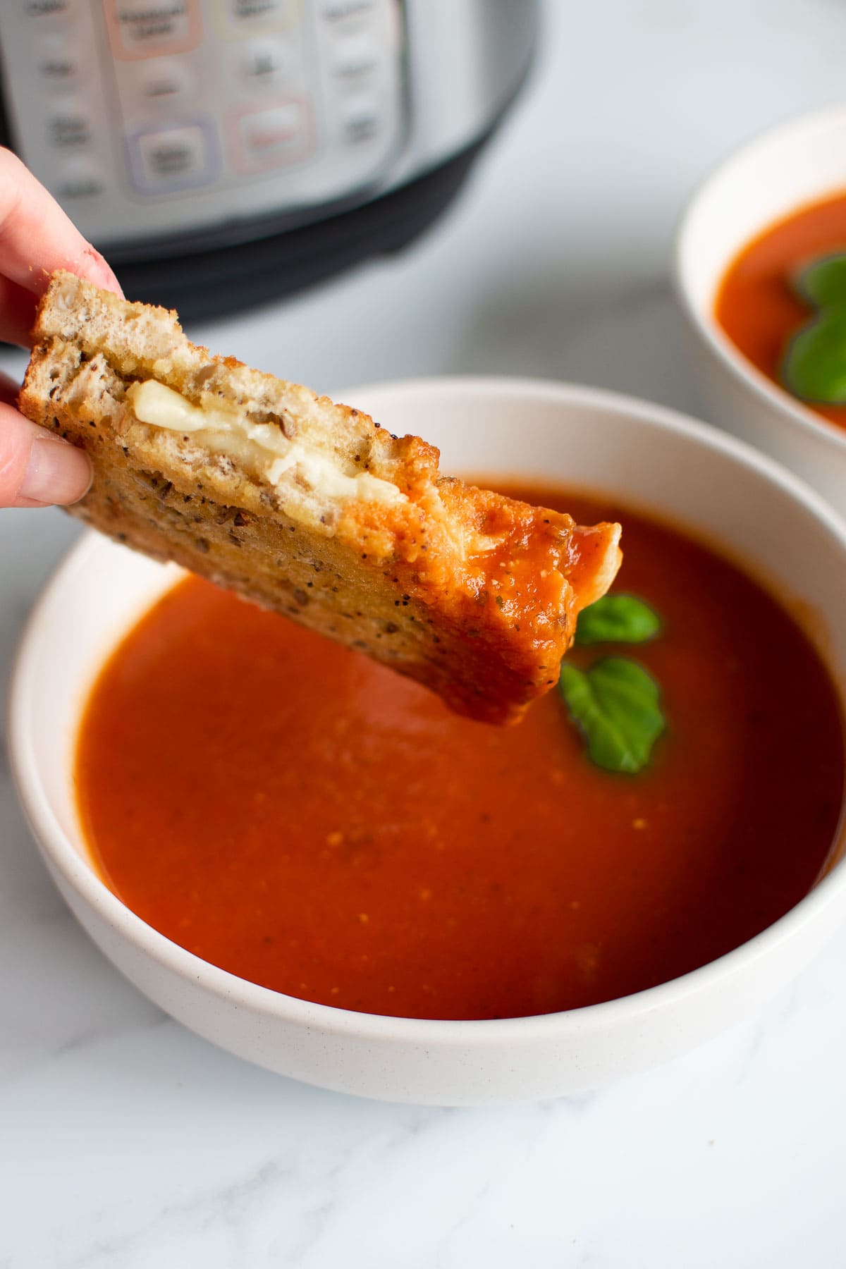 Grilled cheese sandwich dipped in tomato soup.