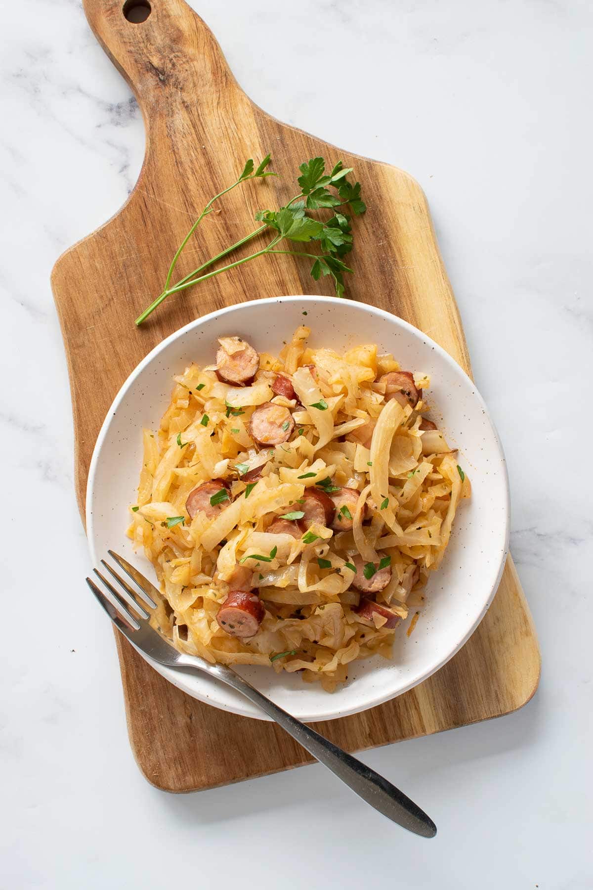 A plate with cabbage and kielbasa.