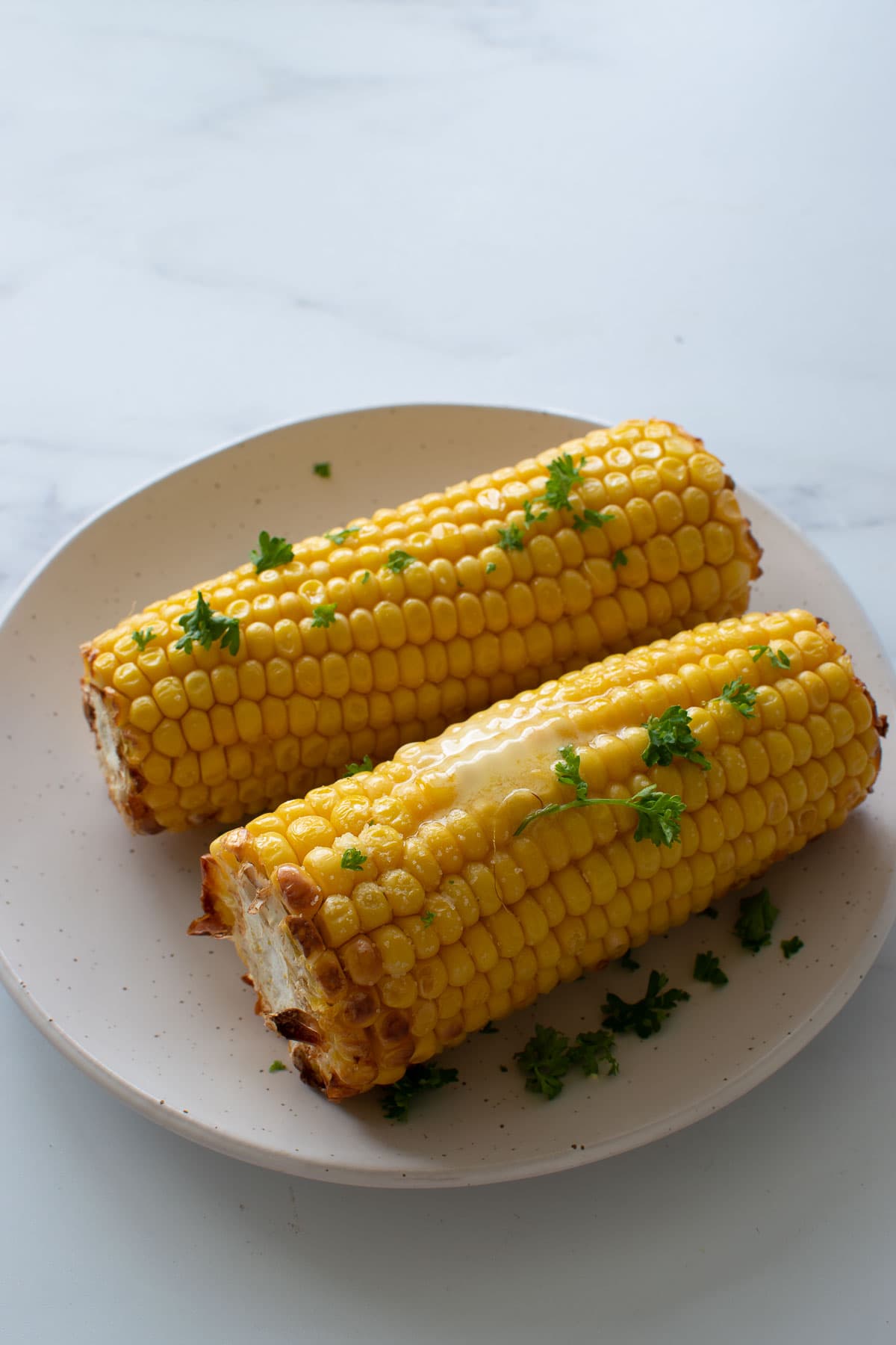 Air fried corn on the cob with melted butter.