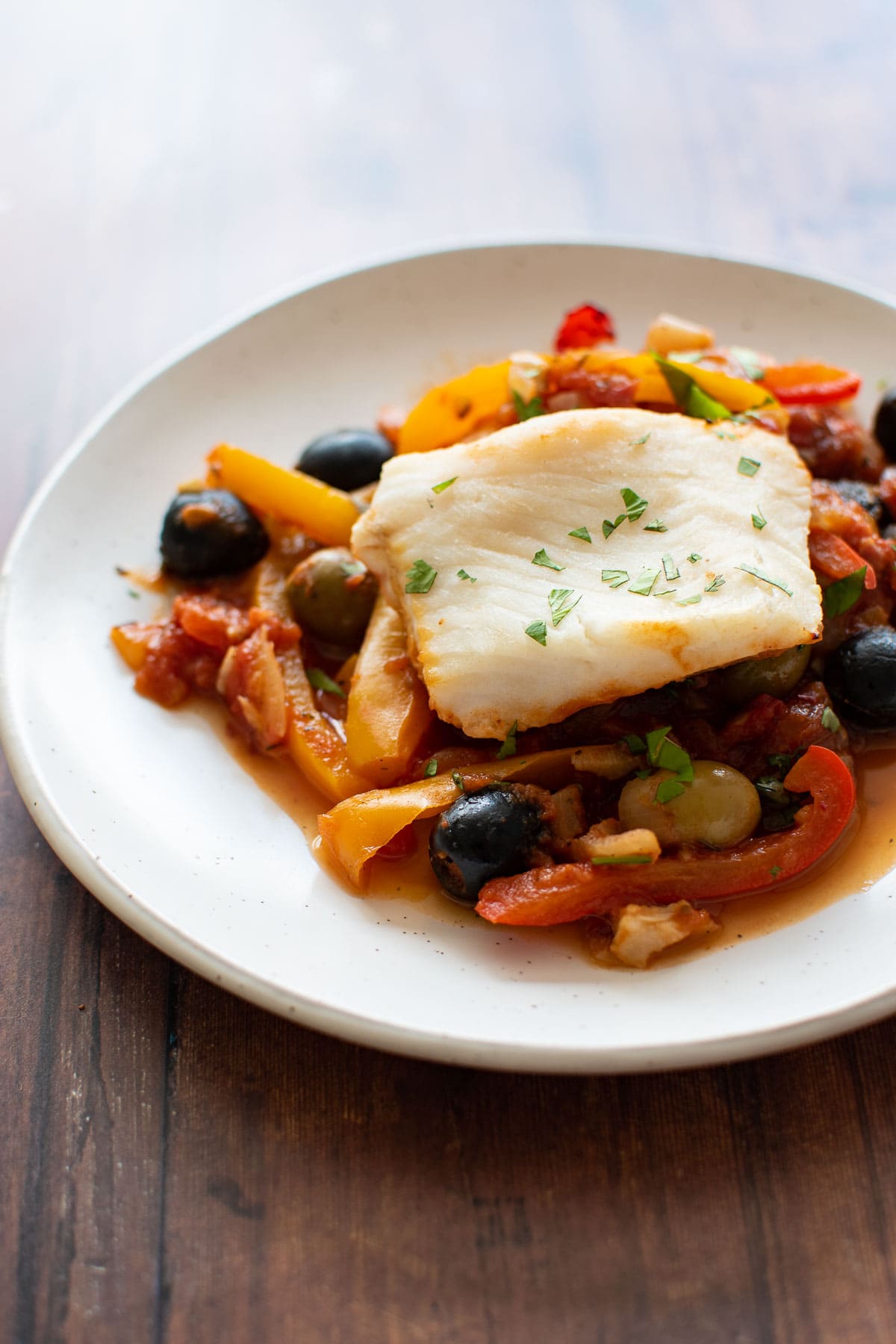 Baked hake and vegetables on a plate.