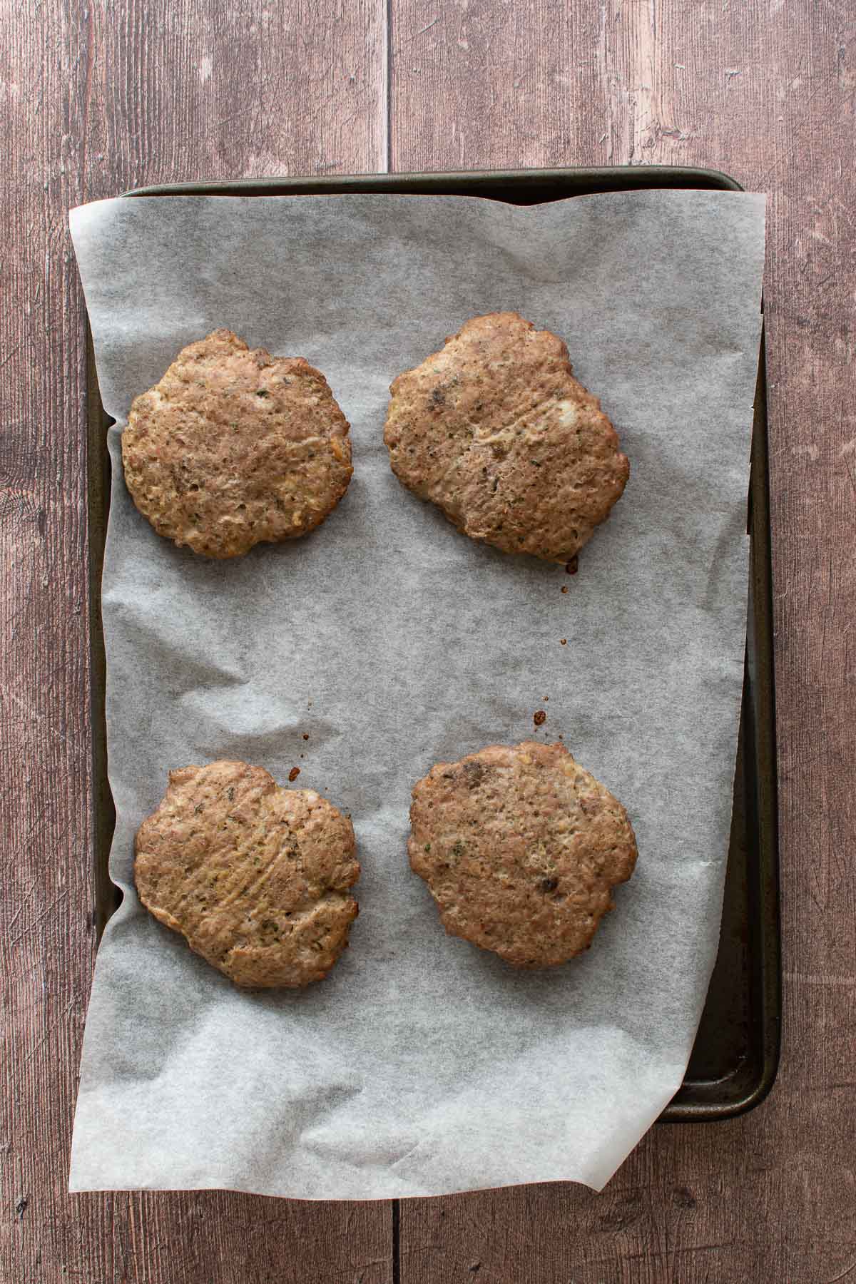 Turkey patties on a baking sheet.