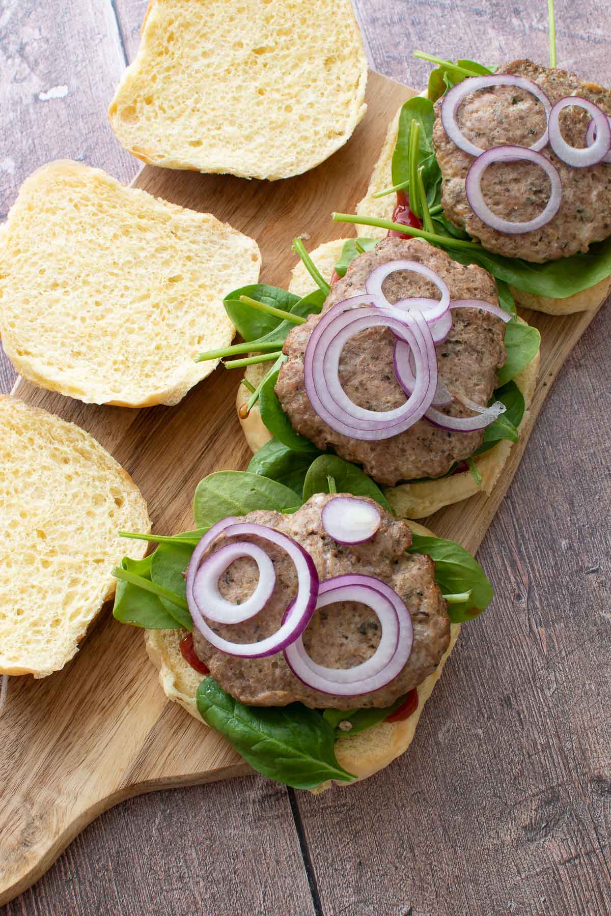 Baked ground turkey burgers with onion.