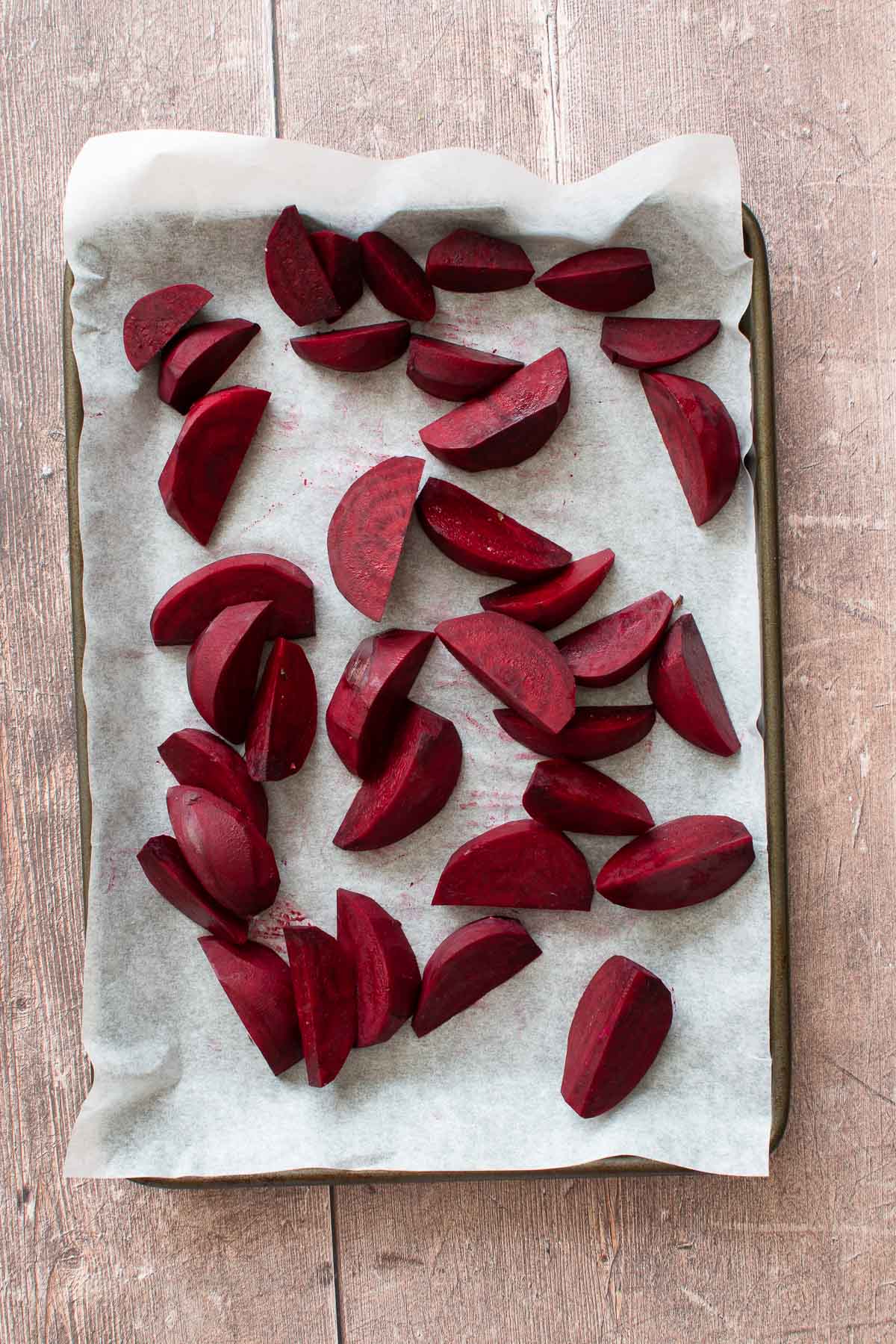 Sliced beetroot on a baking sheet.