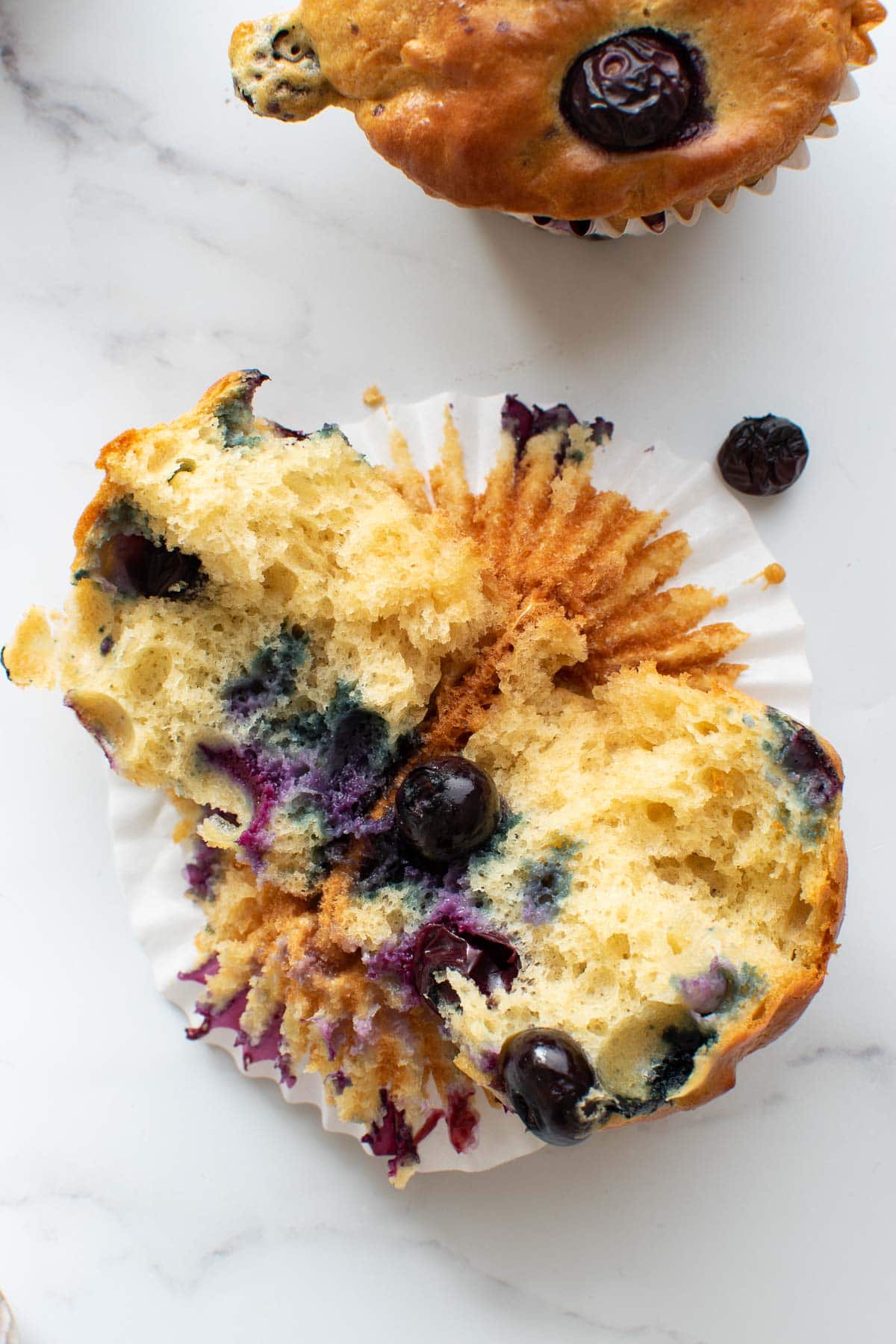 A halved blueberry muffin.