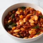 Butter bean and chorizo stew with spinach in a bowl.