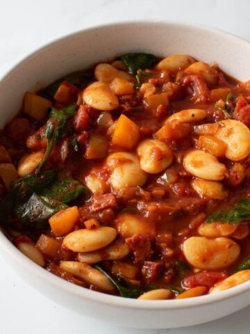 Butter bean and chorizo stew with spinach in a bowl.