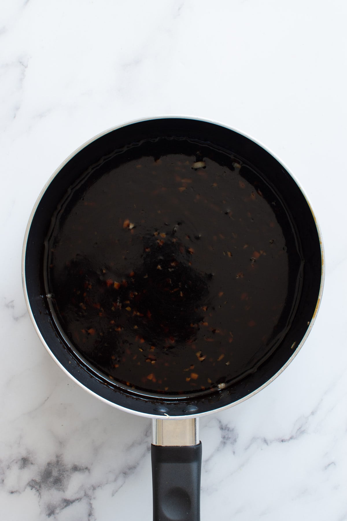 Cooking teriyaki sauce in a pot.