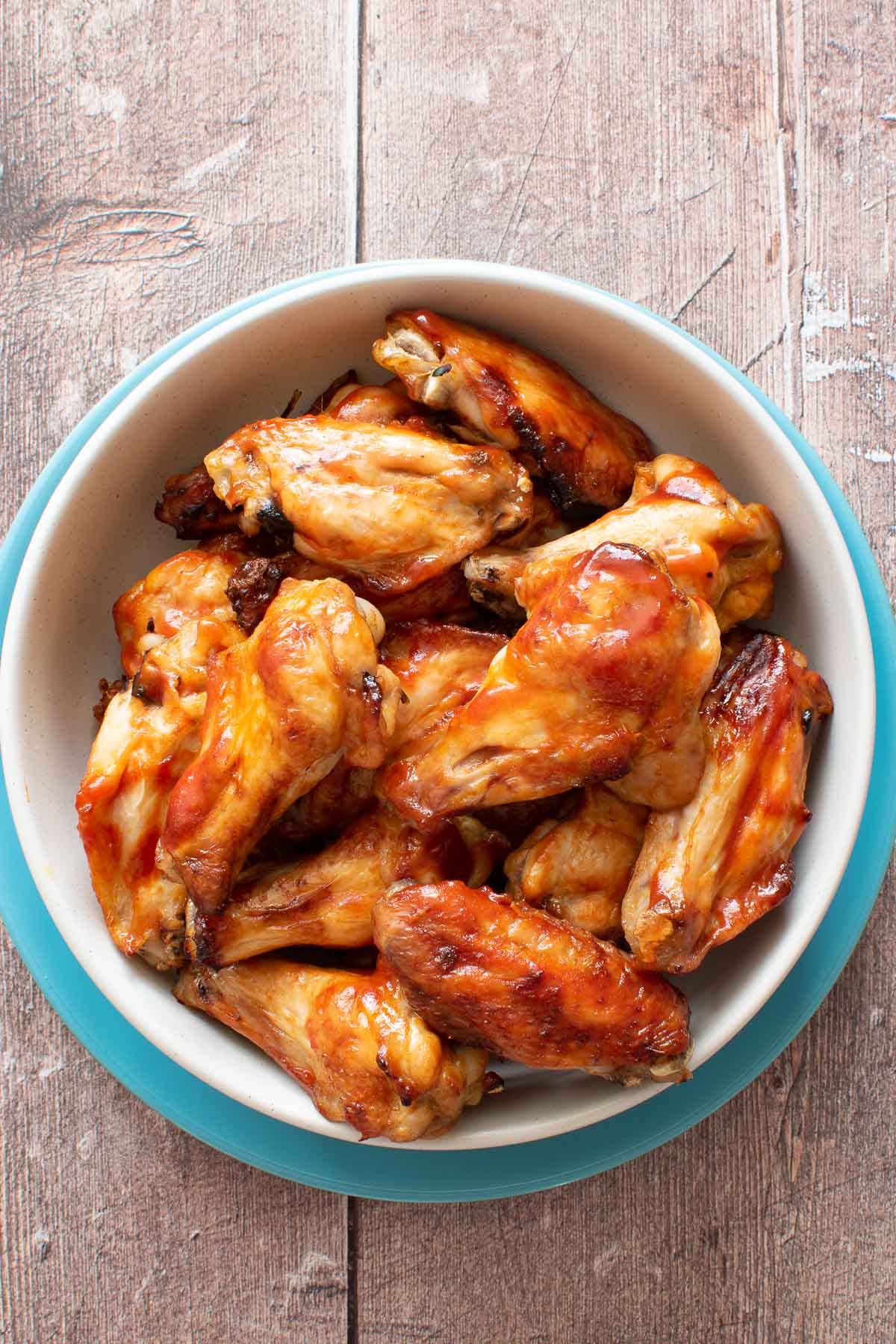 Sriracha honey wings in a bowl.