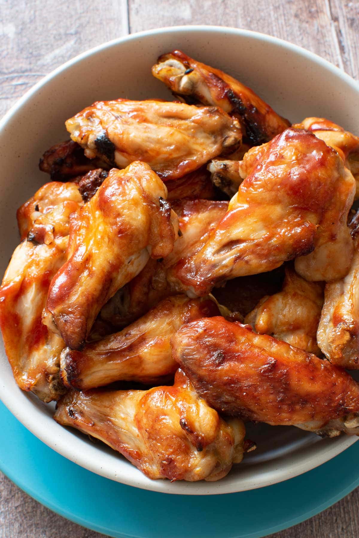 Close up of baked honey and sriracha chicken wings.