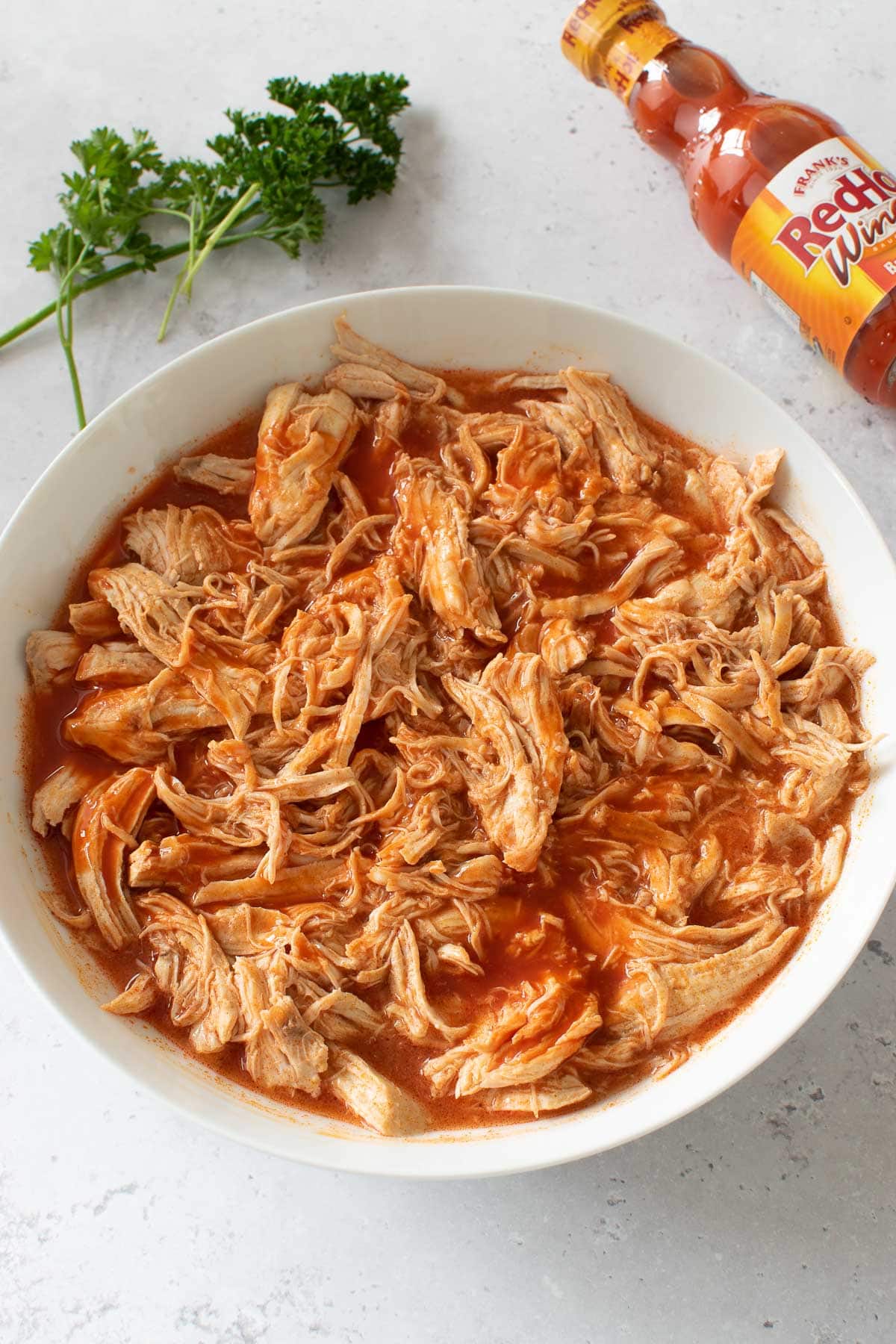 A bowl of shredded buffalo chicken.