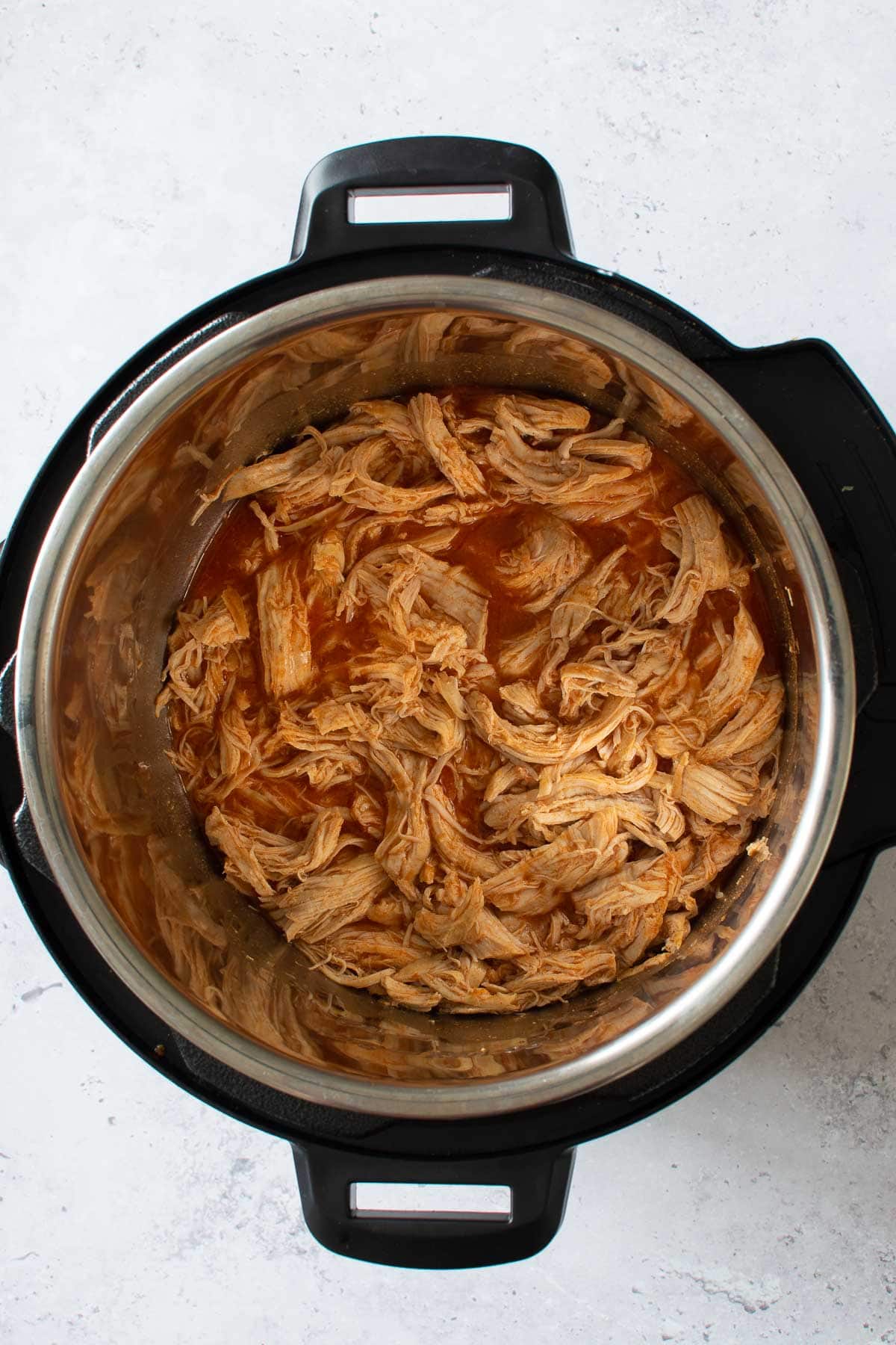 Shredded buffalo chicken in an Instant Pot.