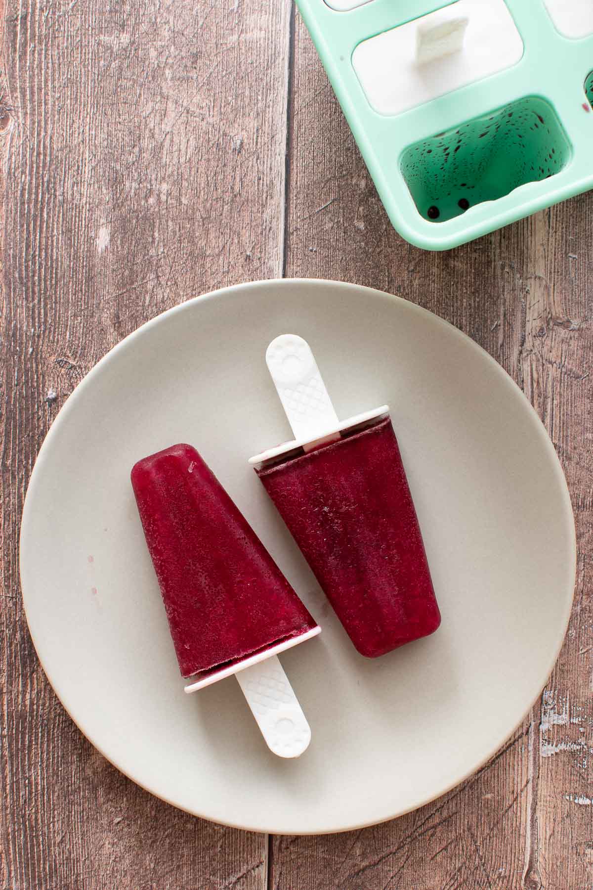 Red wine popsicles on a table.