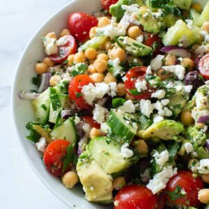 Salad with avocado, chickpeas, feta and tomatoes.