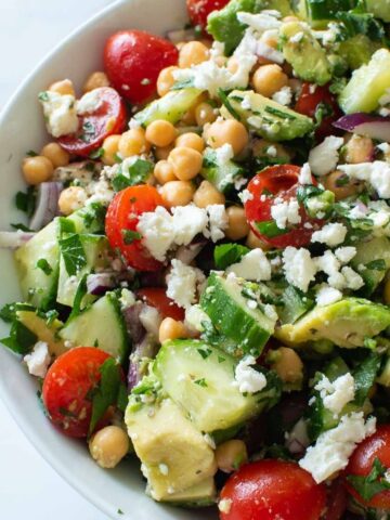 Salad with avocado, chickpeas, feta and tomatoes.