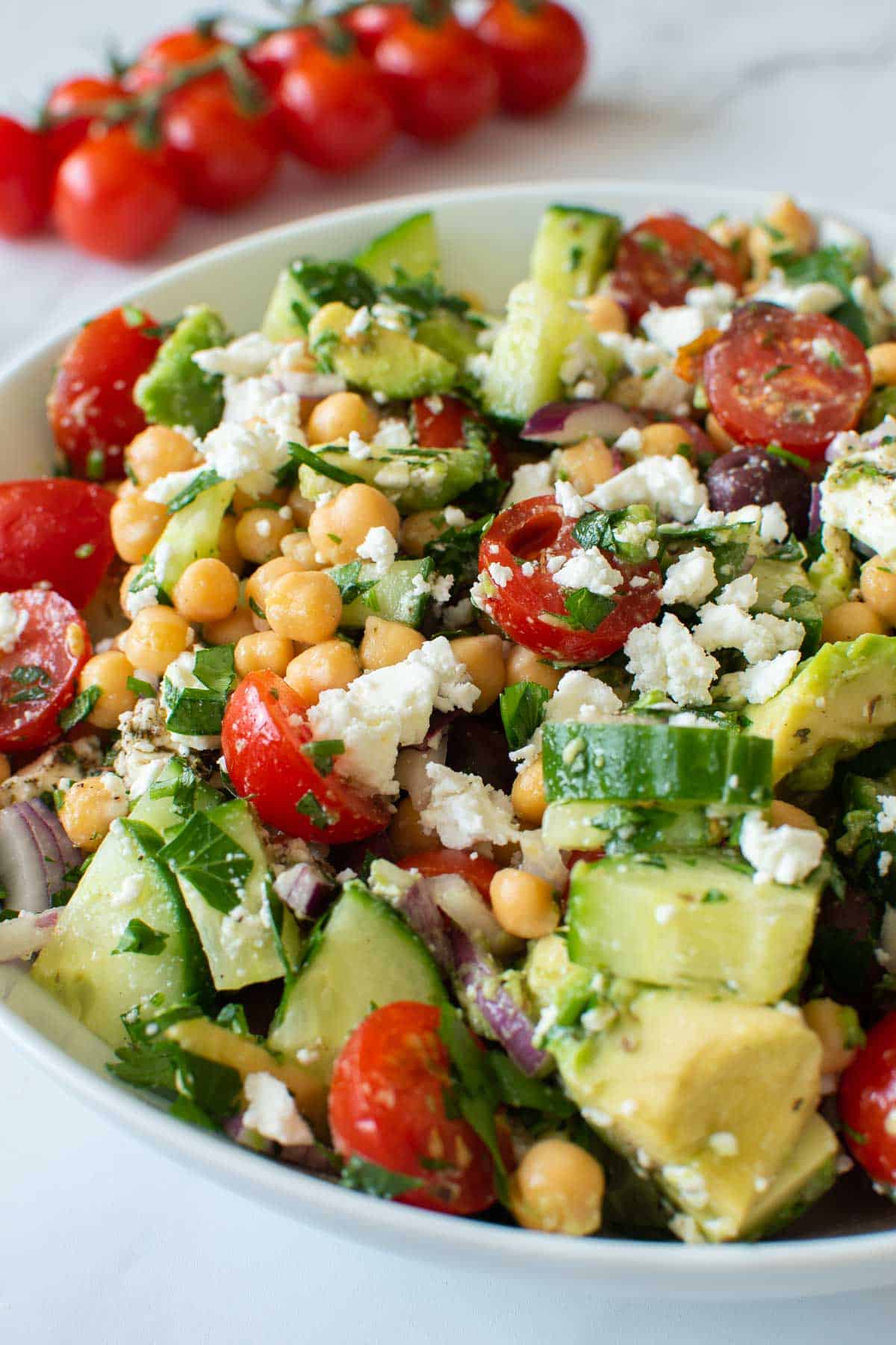 Close up of an avocado chickpea salad with vegetables.