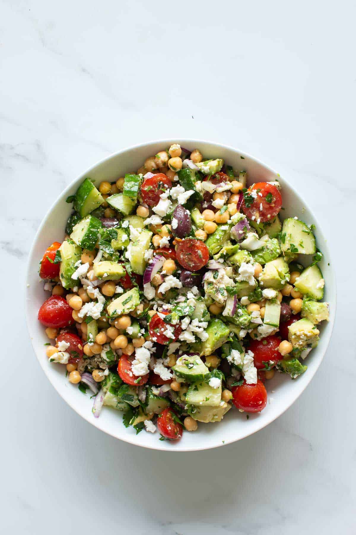 A bowl of mixed chickpea avocado salad.