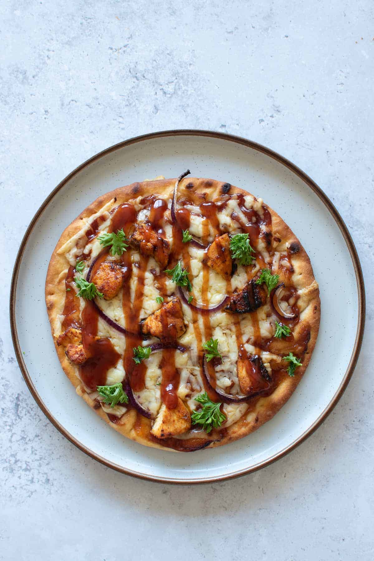 Flatbread with cheddar, chicken and BBQ sauce.
