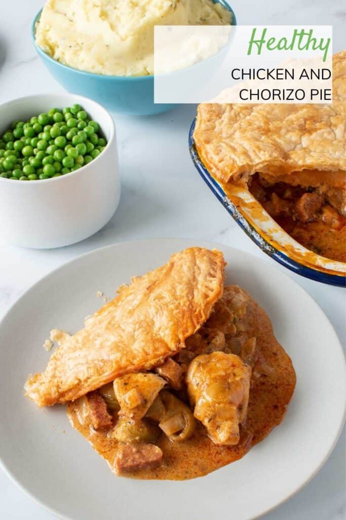 A plate of chicken and chorizo pie with peas and mashed potatoes on the side.