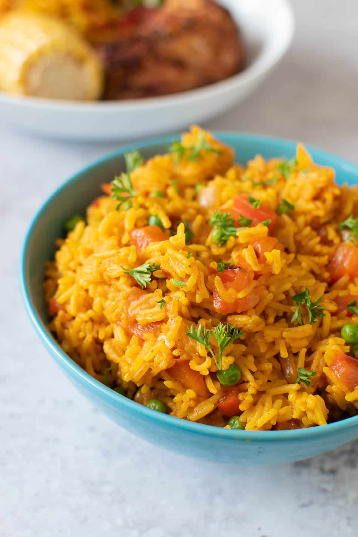 A bowl of nandos yellow rice with chicken.