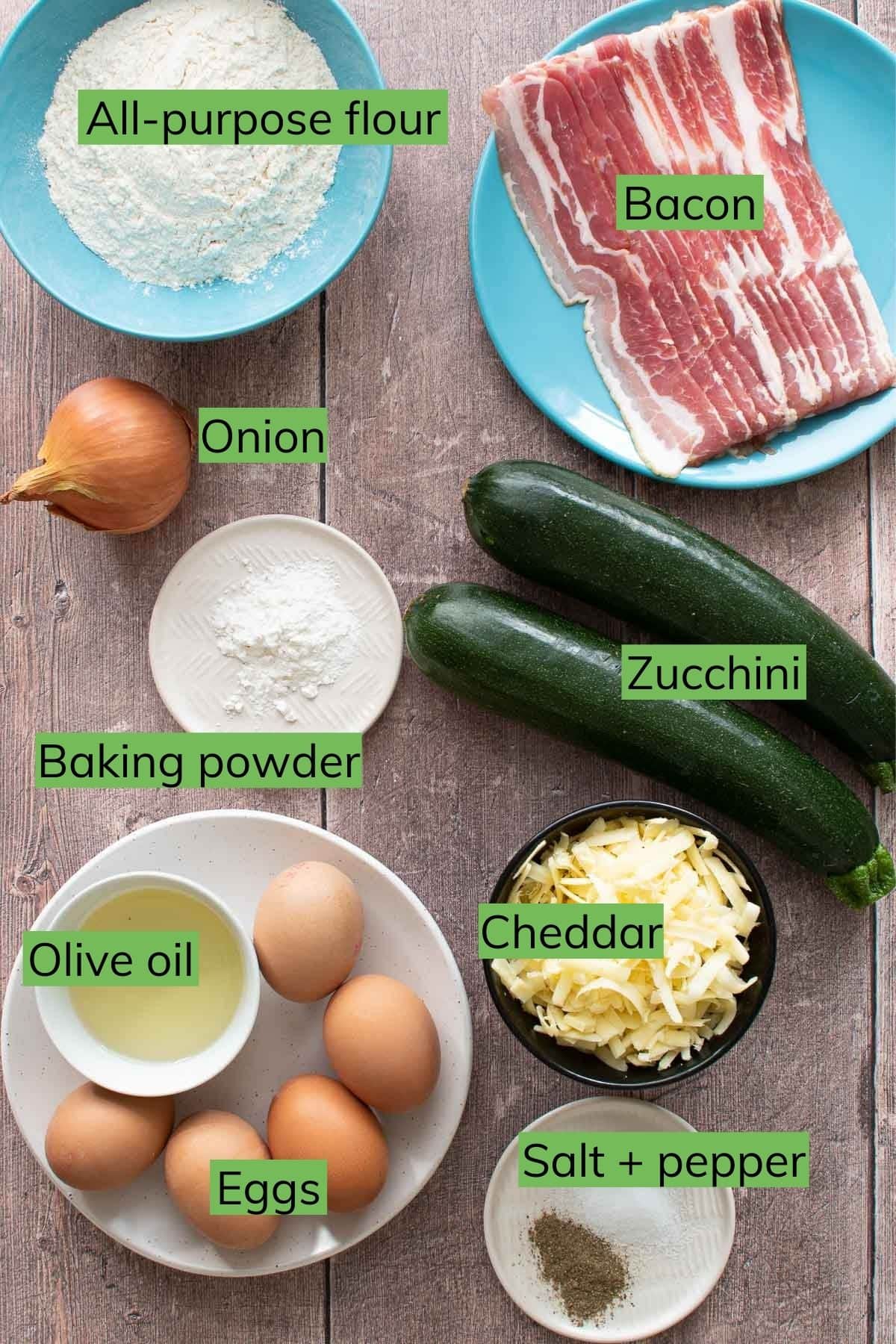 Ingredients needed to make zucchini slice laid out on a table.