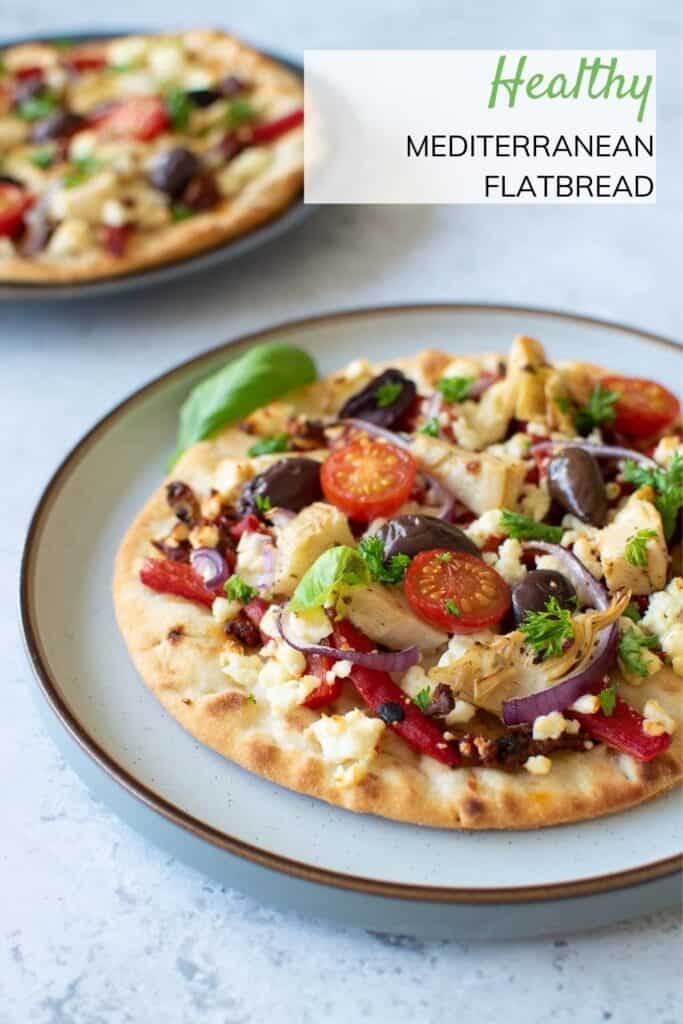 Close up of Greek flatbread with olives and feta.