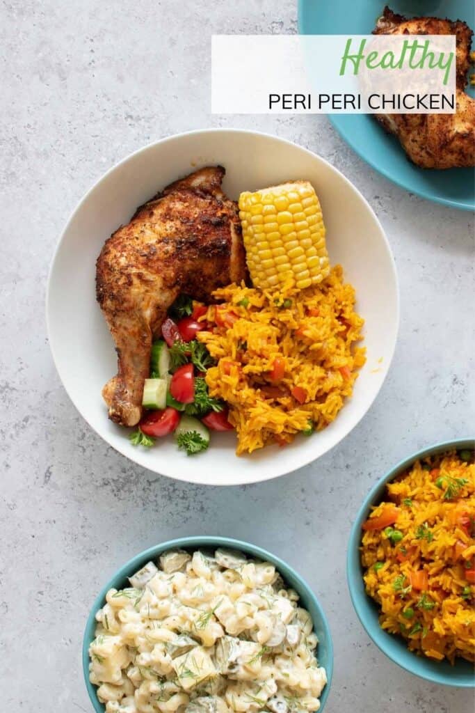 A bowl of baked peri peri chicken with sides.