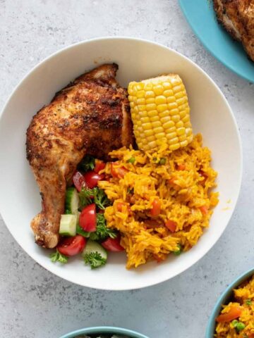 Peri peri chicken with rice, corn on the cob and salad.