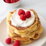 Quark pancakes topped with quark and raspberries.