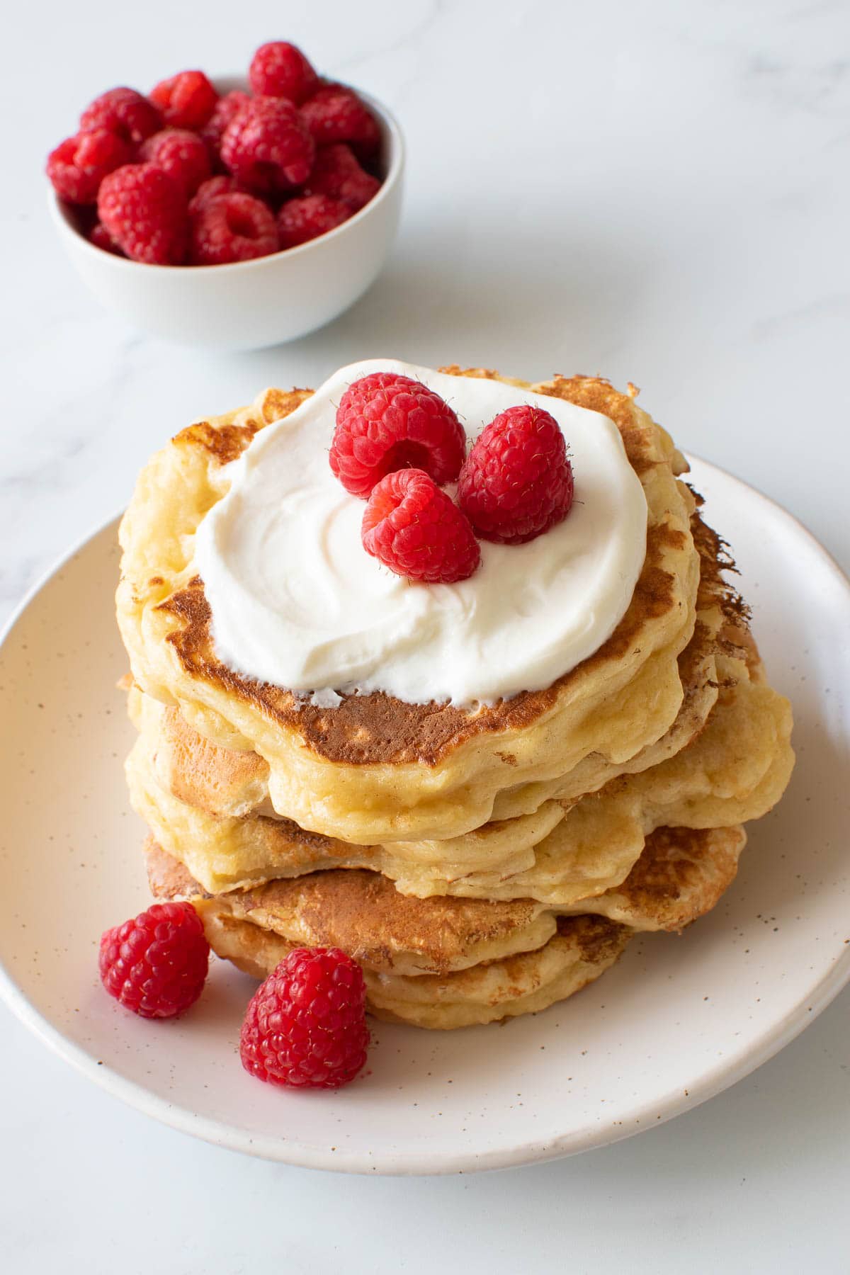 Pancakes with quark, topped with quark and berries.