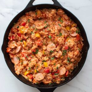 Sausage and rice casserole in a cast iron pan.