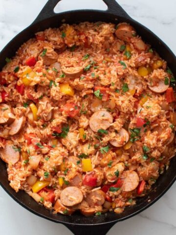 Sausage and rice casserole in a cast iron pan.