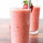 Close up of a pink strawberry peach smoothie.
