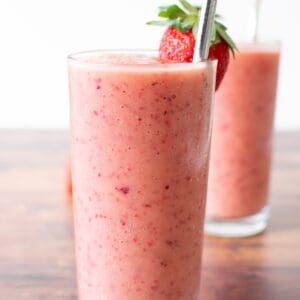 Close up of a pink strawberry peach smoothie.