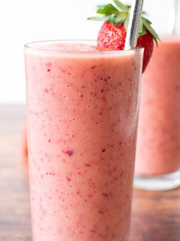 Close up of a pink strawberry peach smoothie.