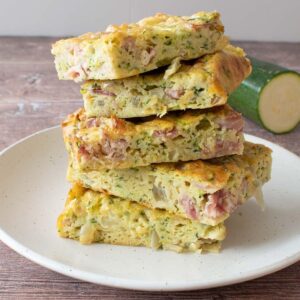 Stacked zucchini slices on a plate.