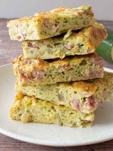 Stacked zucchini slices on a plate.