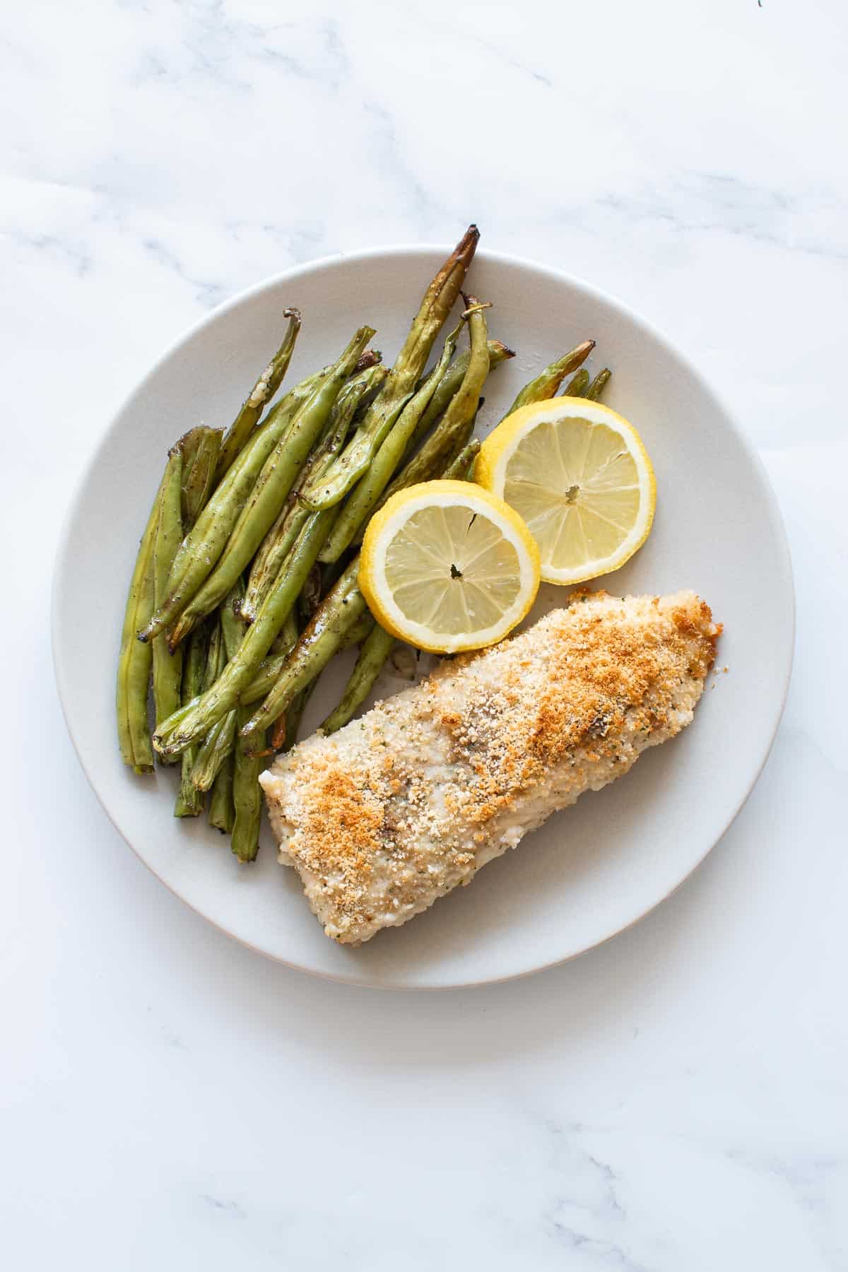 Baked haddock with lemon and green beans.