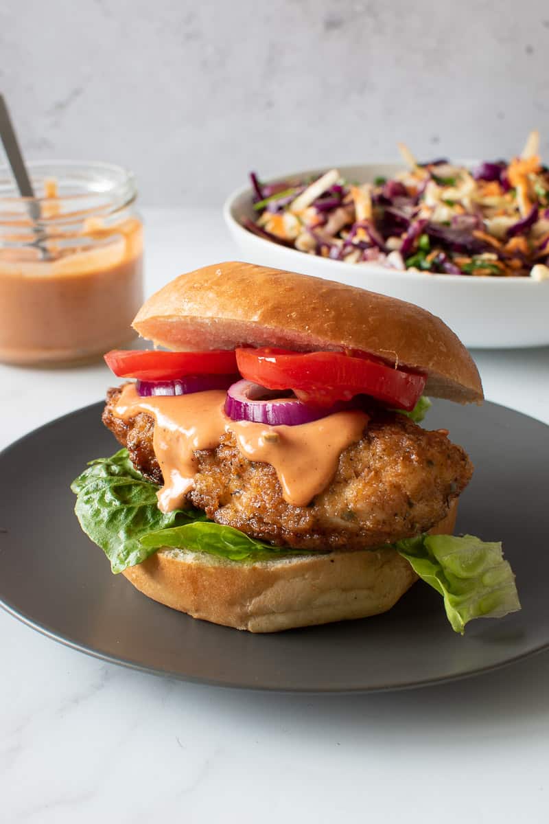 Pan fried chicken burger with burger sauce.