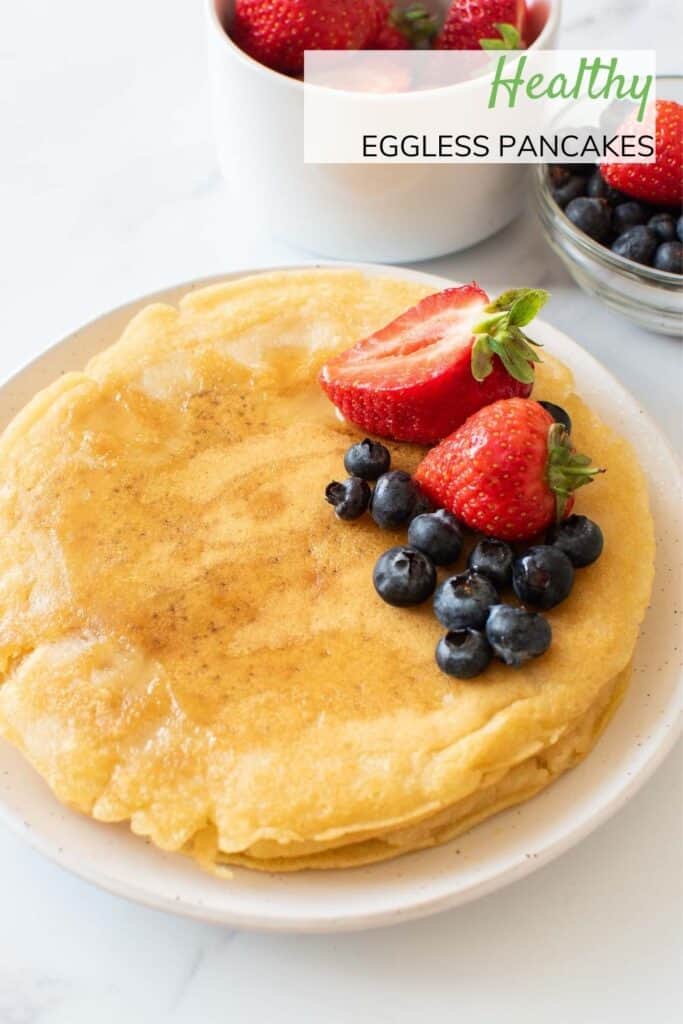 Pancakes with strawberries and blueberries on top.