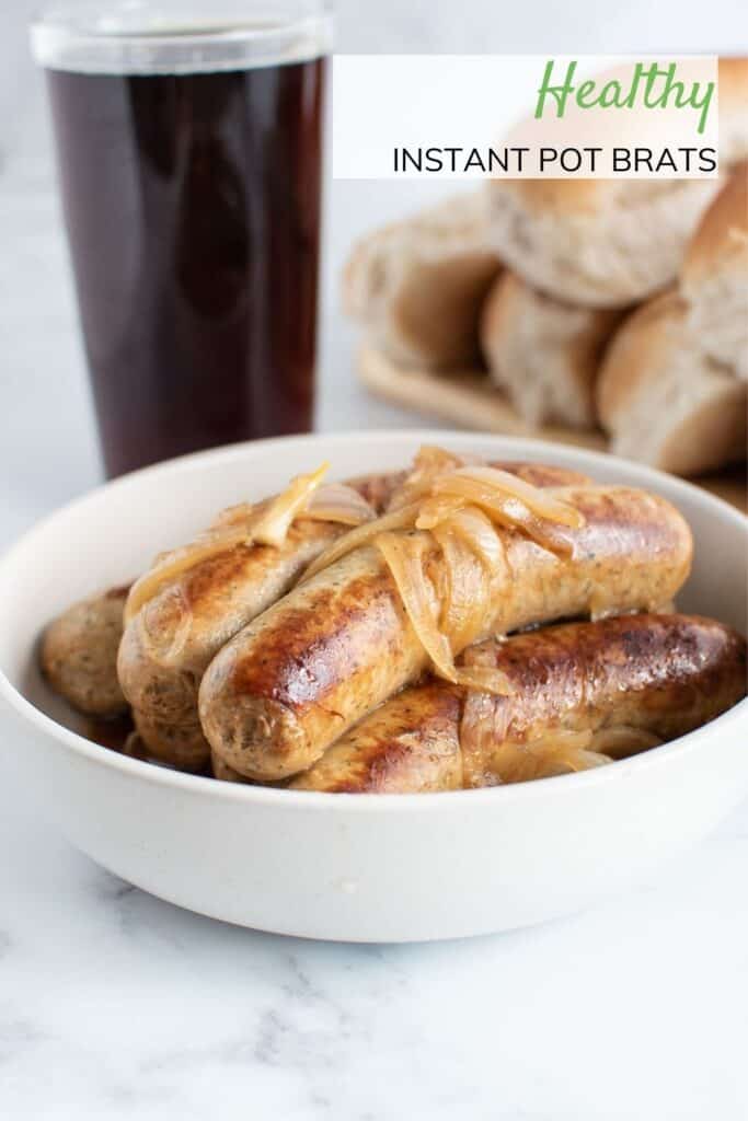 Bratwurst sausages and onion in a bowl.