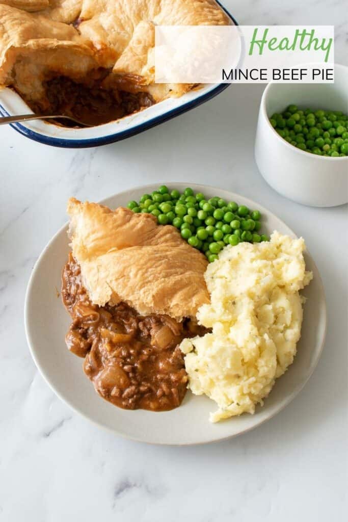 A plate of mince beef pie with side dishes.