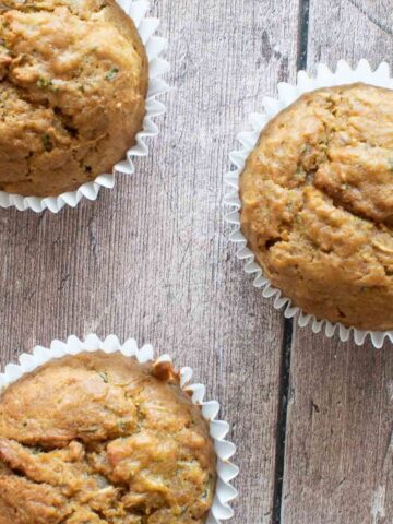 Three pumpkin zucchini muffins.