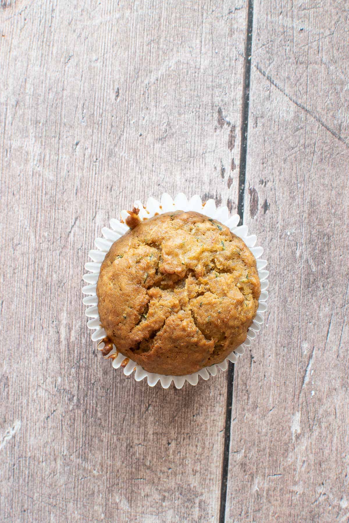 Close up of a pumpkin muffin with zucchini.