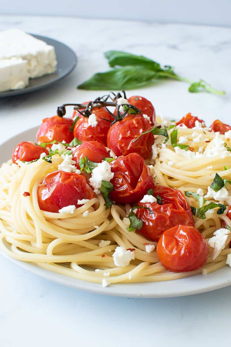 Roasted cherry tomatoes on spaghetti.