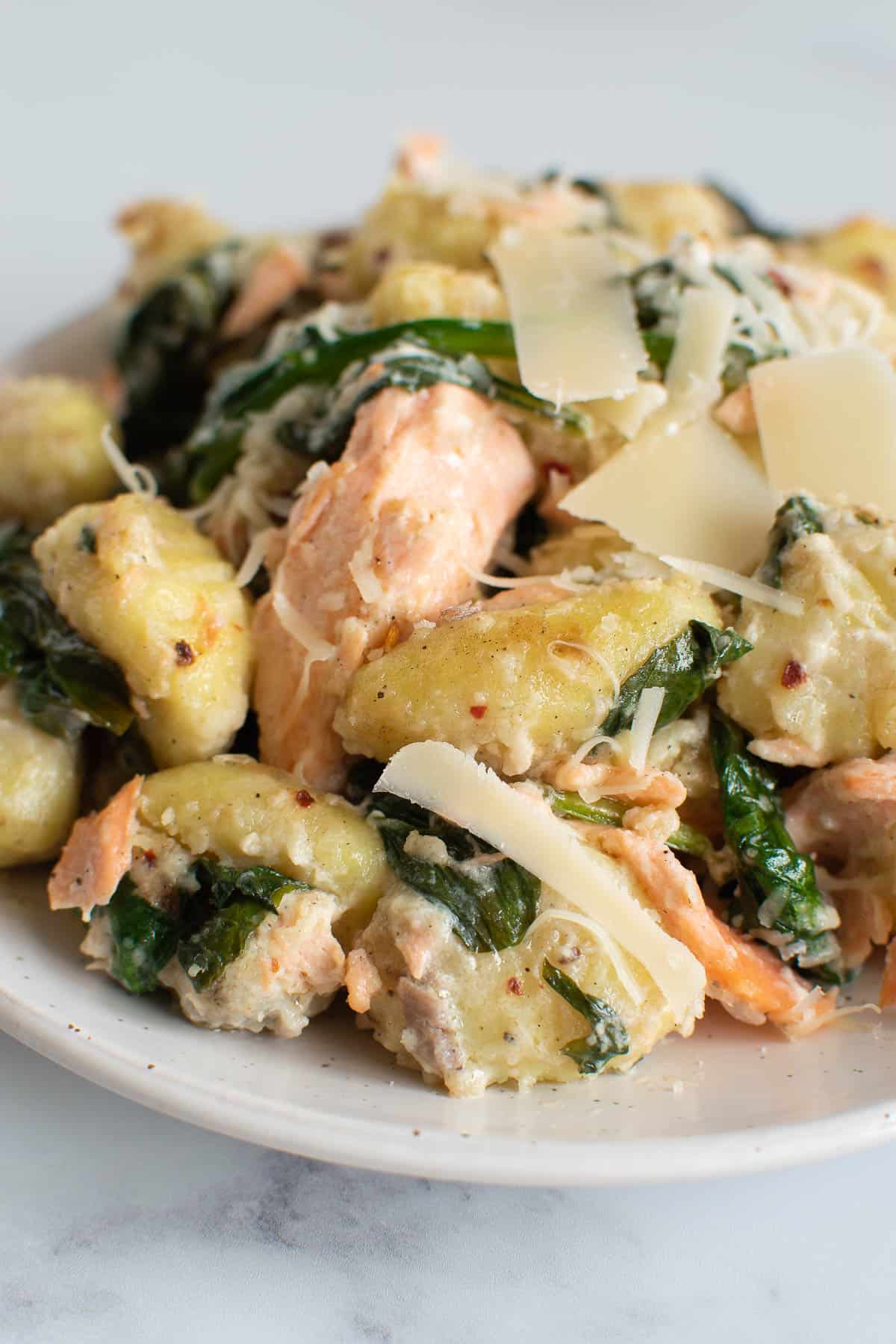 Gnocchi with salmon, spinach and Parmesan cheese.