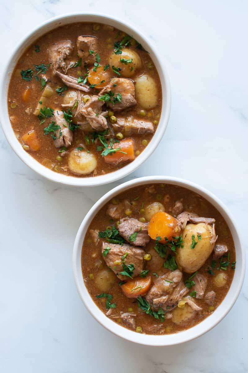 Two bowls filled with slow cooker pork casserole.