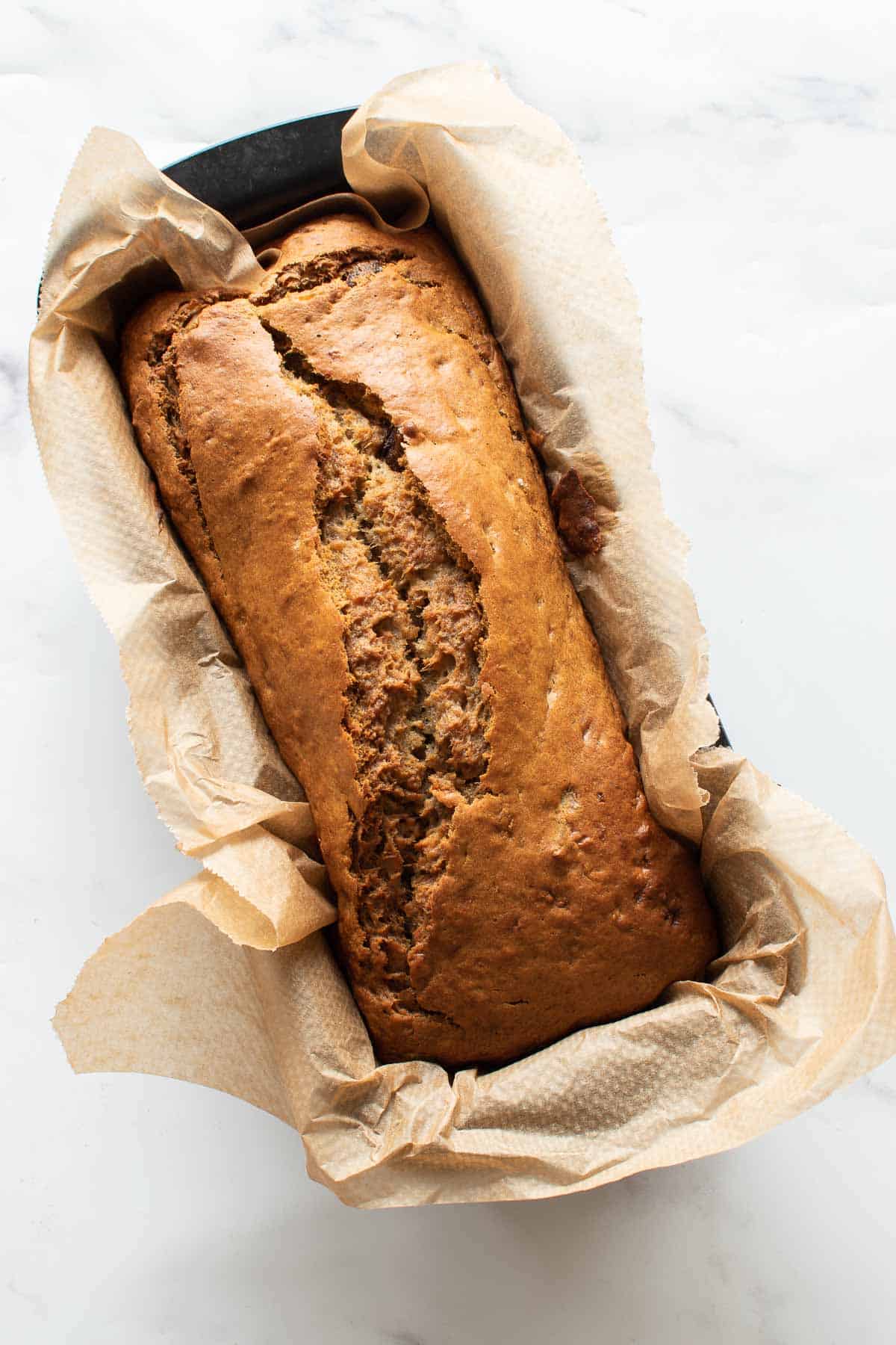 Banana bread with dates in a loaf pan.