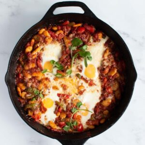 Chorizo baked eggs in cast iron skillet.