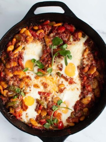 Chorizo baked eggs in cast iron skillet.