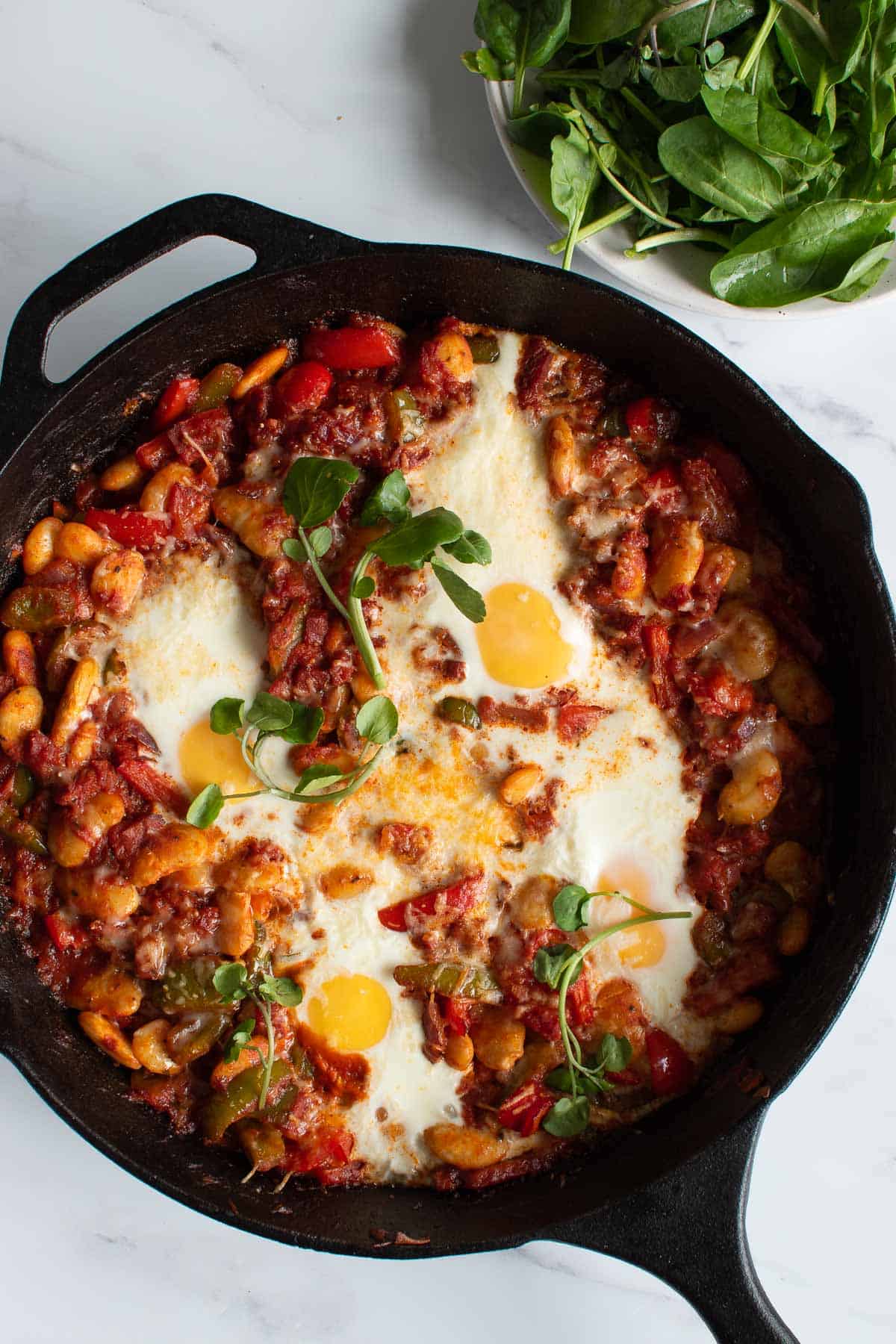 Skillet with baked eggs and chorizo.